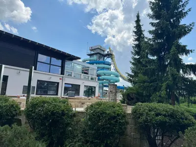 a blue water slide in front of a building at APARTMA MORAVSKE TOPLICE in Moravske Toplice