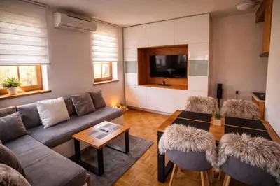 a living room with a couch and a table at APARTMA MORAVSKE TOPLICE in Moravske Toplice