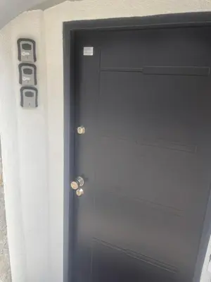 a black door with gold knobs on it at GG art apartments III in Ljubljana