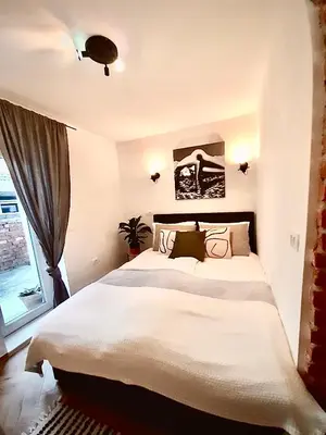 a bedroom with a large bed and a window at GG art apartments III in Ljubljana