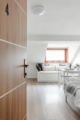 a living room with a couch and a table at Stylish Loft In The Hearth Of Historic Centre in Ljubljana