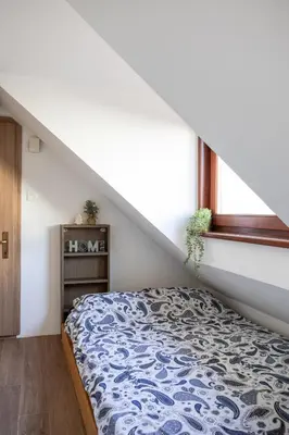 a bedroom with a bed and a stair case at Stylish Loft In The Hearth Of Historic Centre in Ljubljana