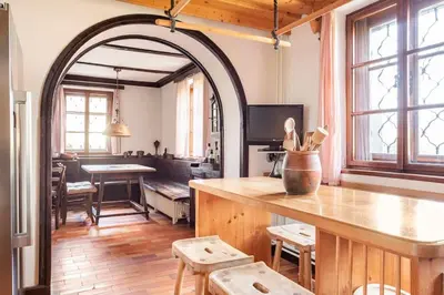 an archway in a living room with a table and chairs at Spacious And Historic Villa With Bled Castle View in Bled