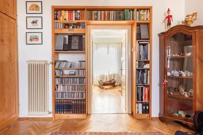 a room with book shelves filled with books at Spacious And Historic Villa With Bled Castle View in Bled