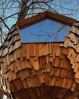 a building made out of wood with a window at T'glamp Bee house in Rovte