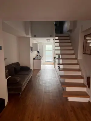 a stairway in a living room with a couch at LiLan apartment in Maribor