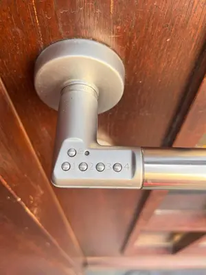 a metal door handle on a wooden door at LiLan apartment in Maribor