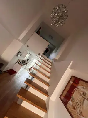 a staircase in a house with a chandelier at LiLan apartment in Maribor