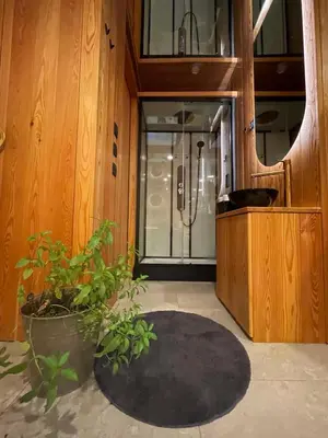 a bathroom with a shower and a black rug at BREZA mobile house BIG BERRY in Metlika