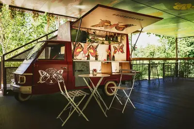 a food truck with a table and chairs in a tent at BREZA mobile house BIG BERRY in Metlika