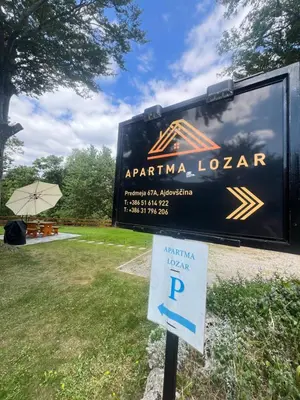 a sign in front of a trailer with a parking sign at Apartma Lozar in Ajdovščina