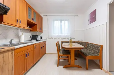 a kitchen with a table and a small table and chairs at Apartma Lozar in Ajdovščina