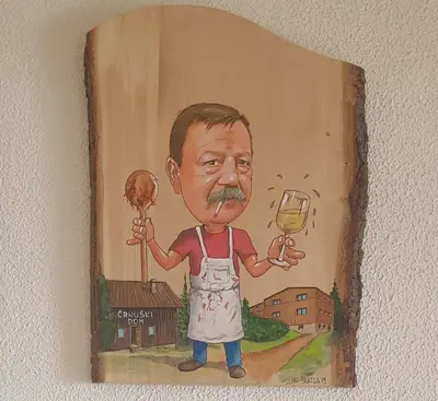 a painting of a man holding a glass of wine at Črnuški dom na Mali planini in Krivčevo