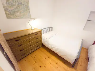 a bedroom with a bed and a dresser at Apartma Florent in Bovec