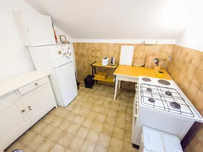 a small kitchen with a stove and a table at Apartma Florent in Bovec