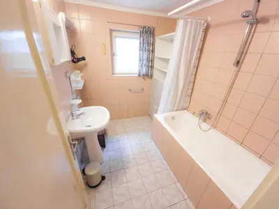 a bathroom with a sink and a tub and a toilet at Apartma Florent in Bovec
