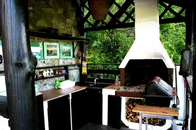 a kitchen with an outdoor oven and a sink at Apartment Šefic in Planina