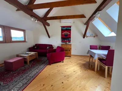 a living room with red furniture and a table at Apartment Šefic in Planina