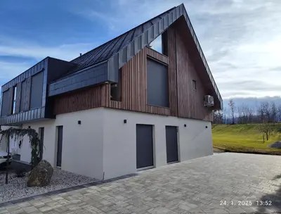 a house with a wooden roof on top of a driveway at LUCKA BLED quiet location, free bikes, big garden, doctor in Bled
