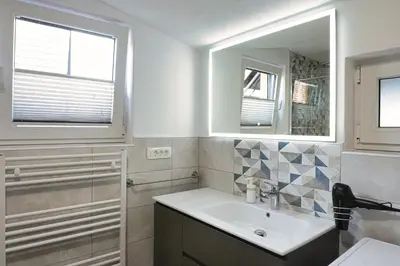 a bathroom with a sink and a mirror at Apartment Pr'pek in Bohinj