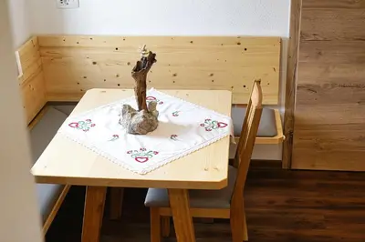 a wooden table and chair with a toy on it at Apartment Pr'pek in Bohinj