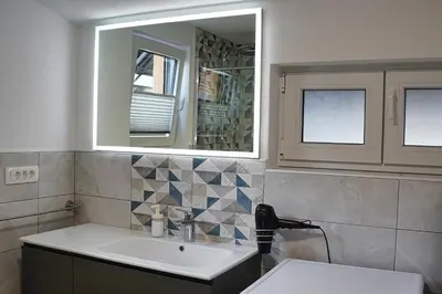 a bathroom with a sink and a mirror at Apartment Pr'pek in Bohinj