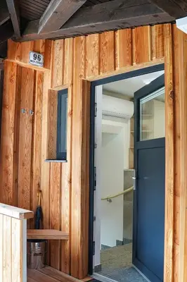 an open door in a room with wooden walls at Apartment Pr'pek in Bohinj