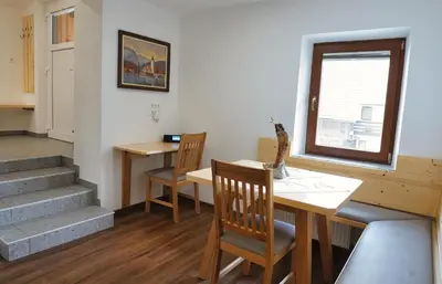 a room with a table and chairs and a window at Apartment Pr'pek in Bohinj