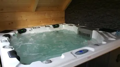 a jacuzzi tub with green water in it at Apartments Klemenčič in Bohinj