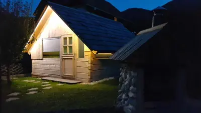 a small house with a door on the side of it at Apartments Klemenčič in Bohinj