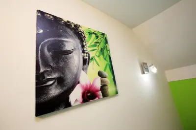a painting of a buddha hanging on a wall at Apartments Klemenčič in Bohinj