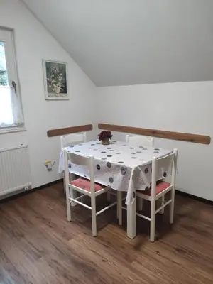 a white table with two chairs and a table with a white tablecloth at Apartments Irena in Kranjska Gora