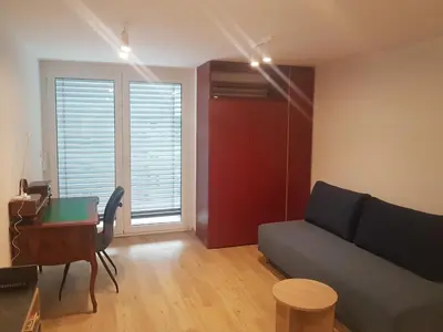 a living room with a couch and a desk at Jojo apartment in Ljubljana