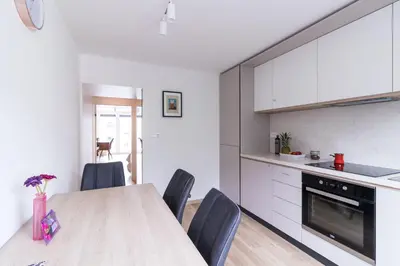 a kitchen with a table and chairs in a room at Jojo apartment in Ljubljana