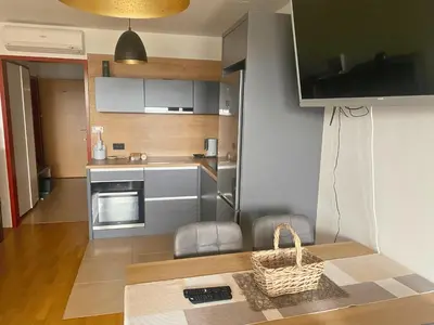 a small kitchen with a table with a basket on it at Apartment Hakuna Matata in Moravske Toplice