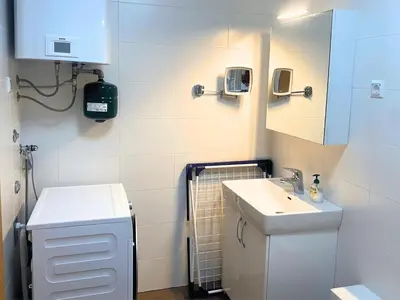 a small bathroom with a sink and a mirror at Apartment Hakuna Matata in Moravske Toplice