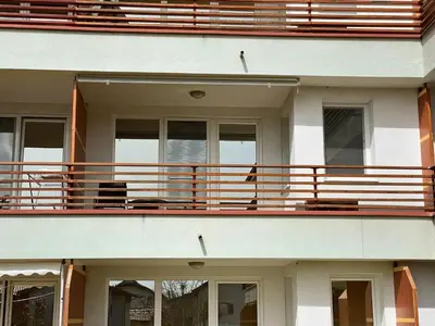 a large white building with a balcony with benches at Apartment Hakuna Matata in Moravske Toplice