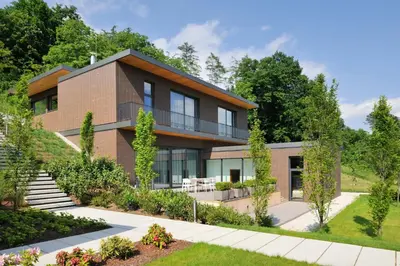 a house with a garden in front of it at Oranda Village in Rogaška Slatina