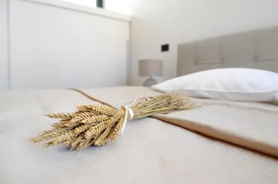 a bundle of wheat sitting on a bed at Oranda Village in Rogaška Slatina
