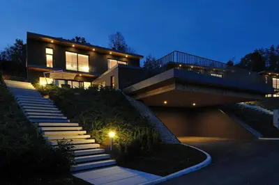 a house with stairs leading up to it at night at Oranda Village in Rogaška Slatina