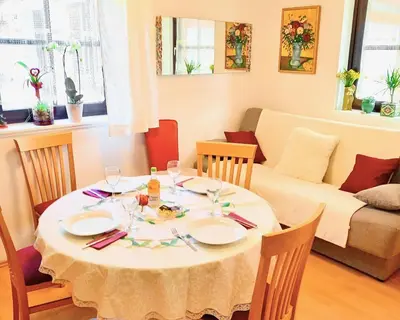 a dining room table with a white table cloth at Miabella House - 2 bedrooms and terrace in Brežice