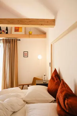 a bedroom with two beds and a window at MÓD in Lendava