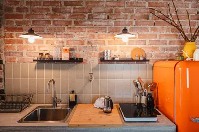 a kitchen with a sink and an orange refrigerator at MÓD in Lendava