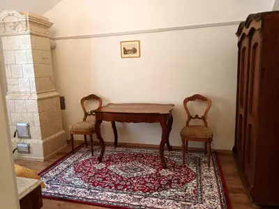 a room with a table and two chairs on a rug at Rezidenca Sv. Peter in Malečnik