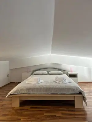 a bedroom with a bed with two pillows on it at Apartment Štucin in Vipava