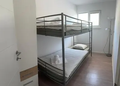 a bedroom with two bunk beds in a room at Apartment Štucin in Vipava