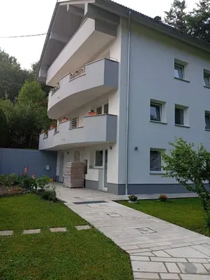 a white building with balconies on the side of it at RELAX in Kamnik