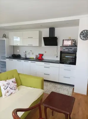 a living room with a couch and a kitchen at RELAX in Kamnik