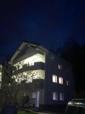 a building with lights on the side of it at night at RELAX in Kamnik