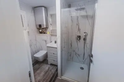 a white bathroom with a shower and a toilet at Apartment Zarja - Trije Kralji in Zgornja Ložnica